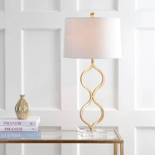 Lampada da tavolo LED di design con stelo curvato color oro e paralume cilindrico